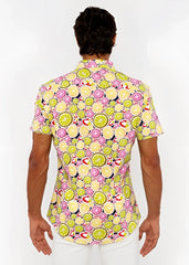 A fruits print stretch knit shirt with lime and pink citrus slices on a dark navy background in a short sleeve design