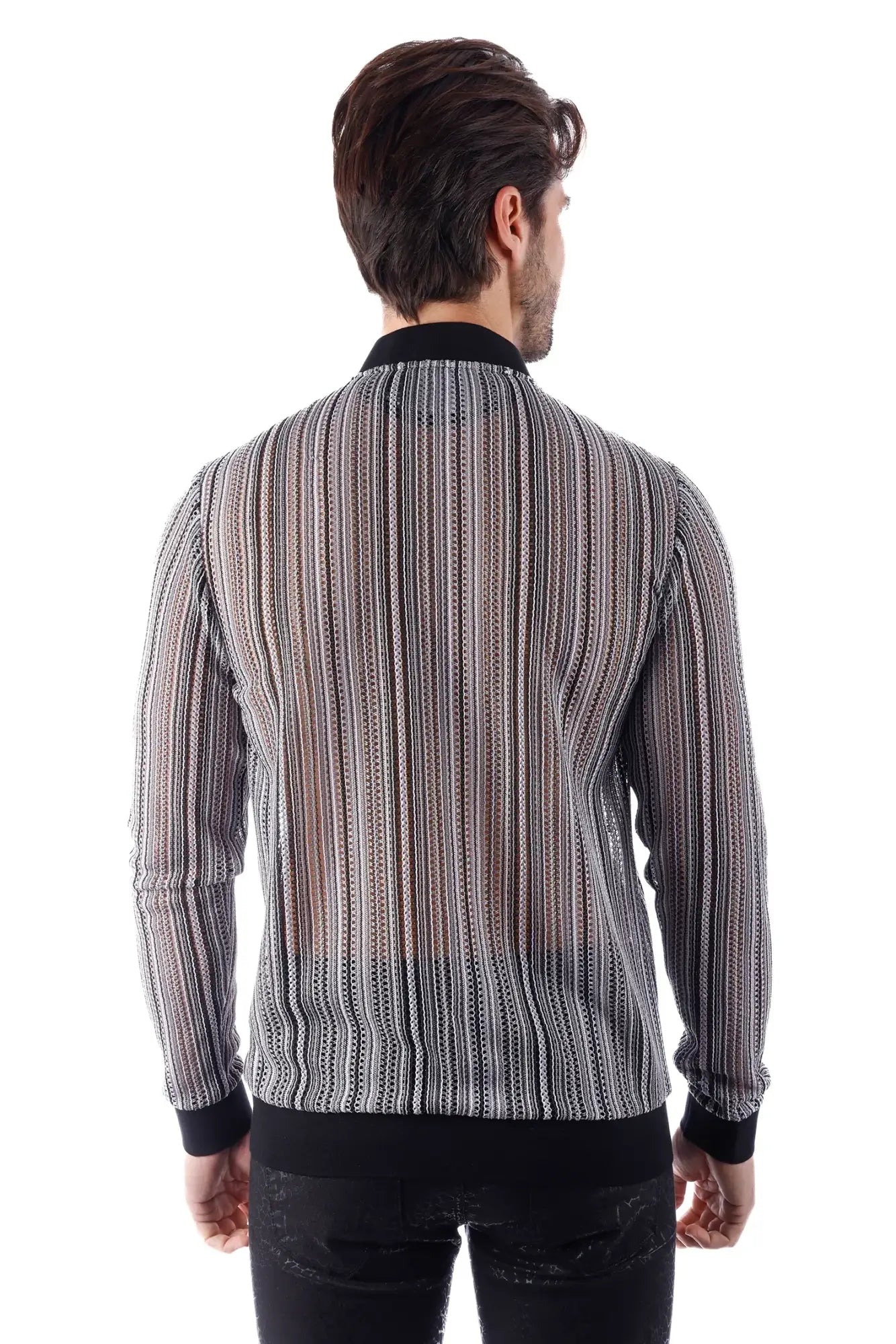 A man wearing a funky novelty bomber jacket with black and white striped sheer patterned long sleeves