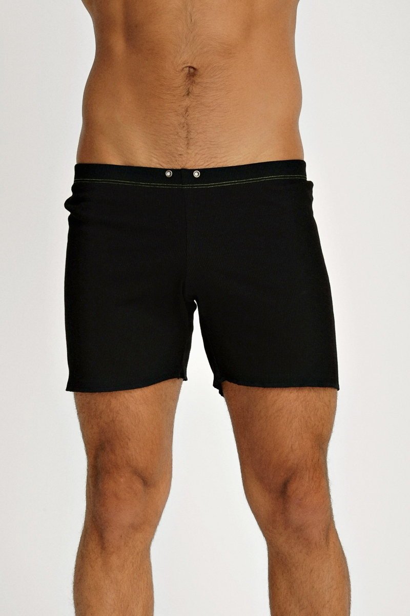 Black fusion yoga short swim trunks with sleek minimalist design and subtle stitching along the waistband