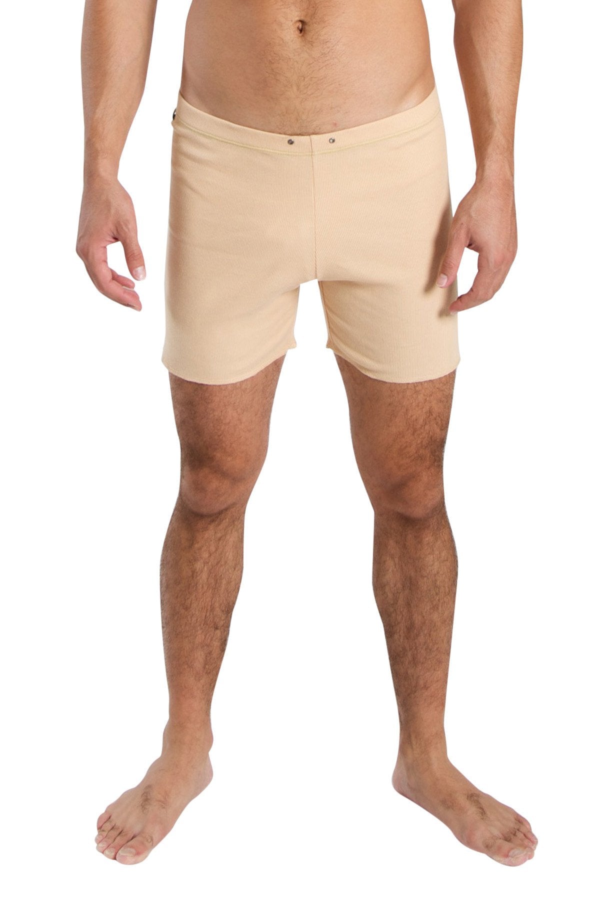 Beige fusion yoga short in form-fitting smooth fabric with subtle front seam detail ideal for swim or activewear