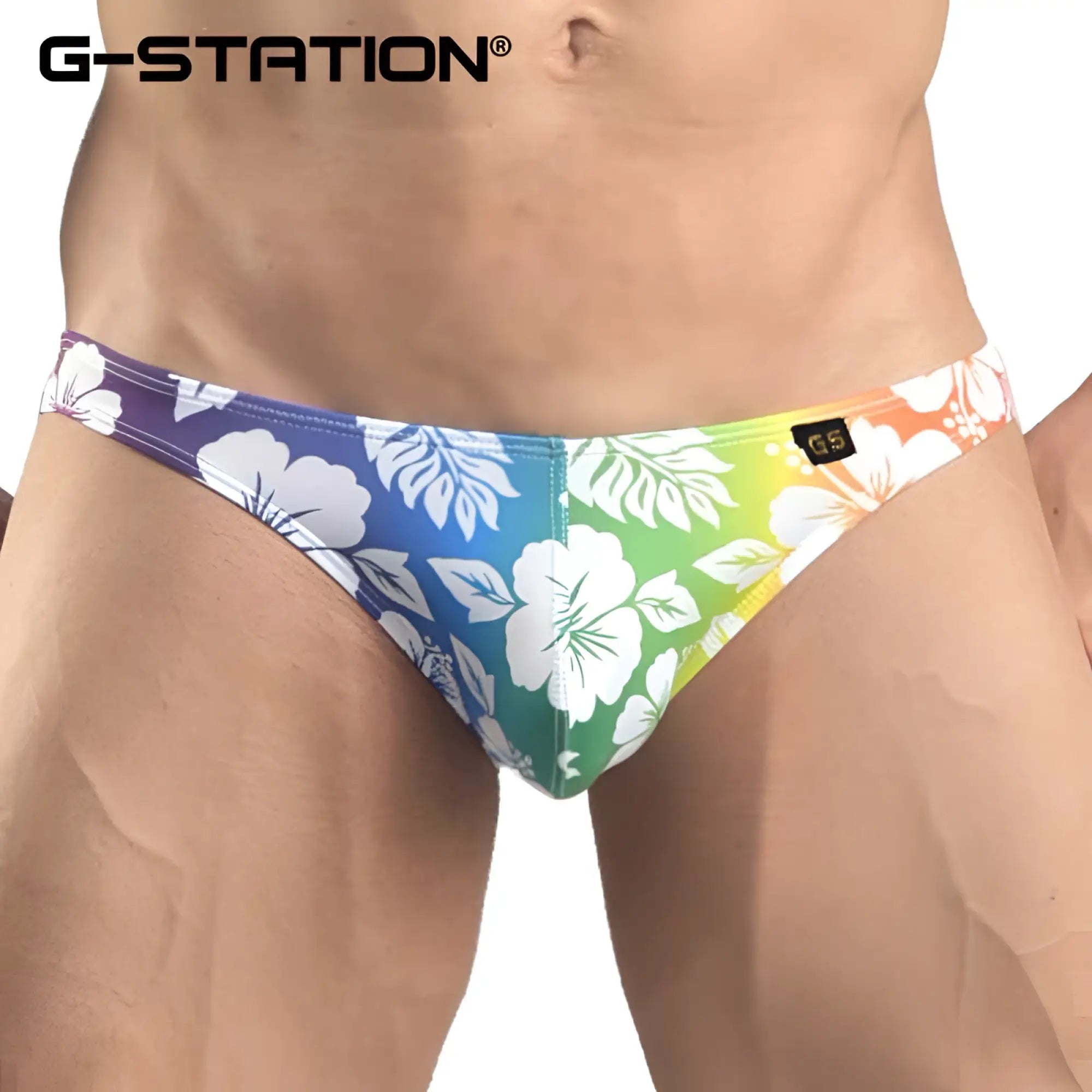 G-station hibiscus bikini underwear men’s swim trunks with vibrant tropical floral pattern on rainbow gradient background