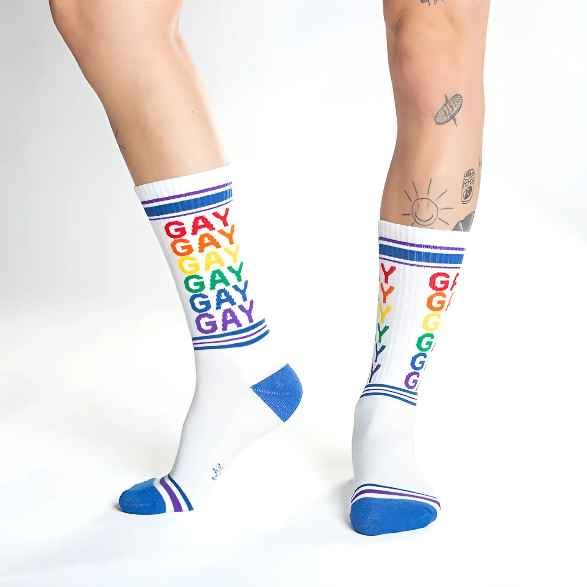 White crew socks with rainbow gay text and blue toe heel and cuff accents for pride and casual wear