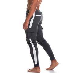 Dark gray Gigo Atleta sportpants with bold white side stripes and cargo pockets designed for athletic use
