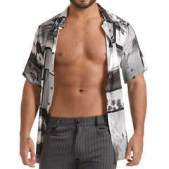 A man wearing a gigo charles shirt short-sleeved button-up with black and white coastal palm tree print