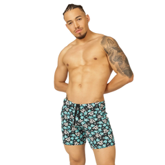 Menâ€™s swim trunks with black base teal and white skull patterns and matching drawstring waistband from Gigo Comics Beachwear