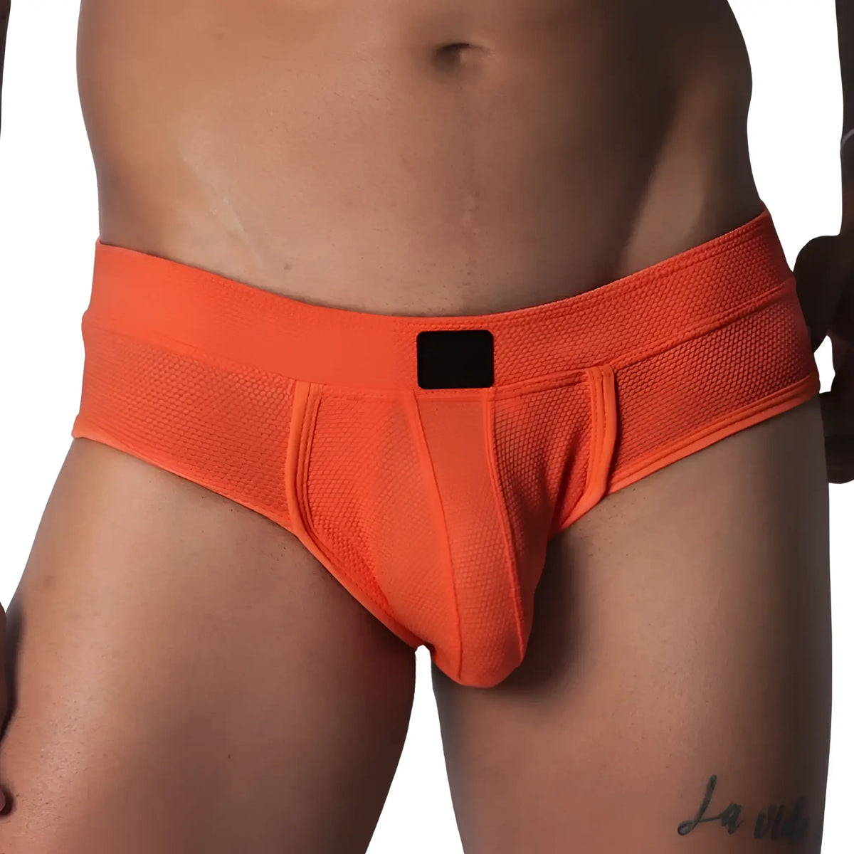 Bright orange textured micro-mesh brief with a supportive pouch and a solid black logo tag on the center waistband.