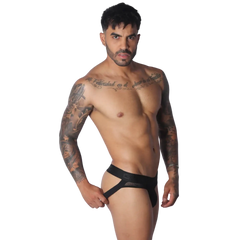 Black jockstrap with mesh side panels and a wide branded elastic waistband on a tattooed model.
