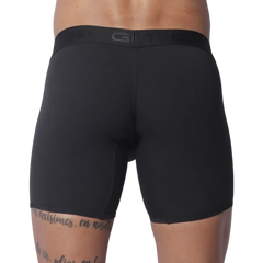 Solid black fitted boxer trunks with a wide, tonal branded elastic waistband.