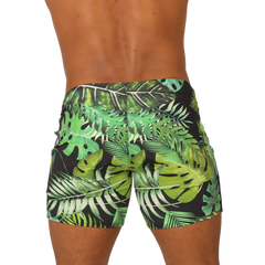 Black swim trunks from gigo forest beachwear with vibrant green and white tropical leaf pattern for beach use