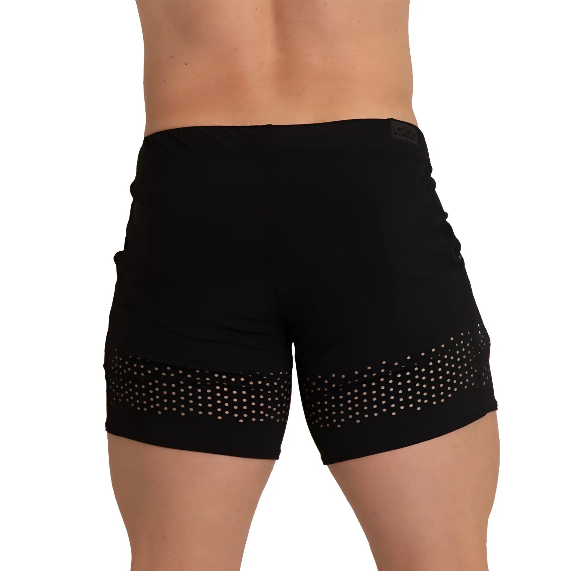 Black athletic shorts with white polka dot mesh panel along the lower hem from gigo hole black beachwear collection