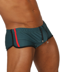 Gigo Nice Green swim trunk in teal with a bold red stripe and black trim designed for athletic use