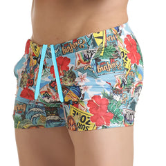 Gigo Seventies beachwear brightly colored swim trunks with tropical collage print on light blue fabric