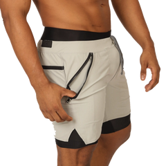 Light gray gigo sporty shorts with black trim and zippered side pocket for athletic use