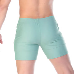 Mint green athletic shorts with elastic waistband and sleek form fitting design from gigo traditional green beachwear