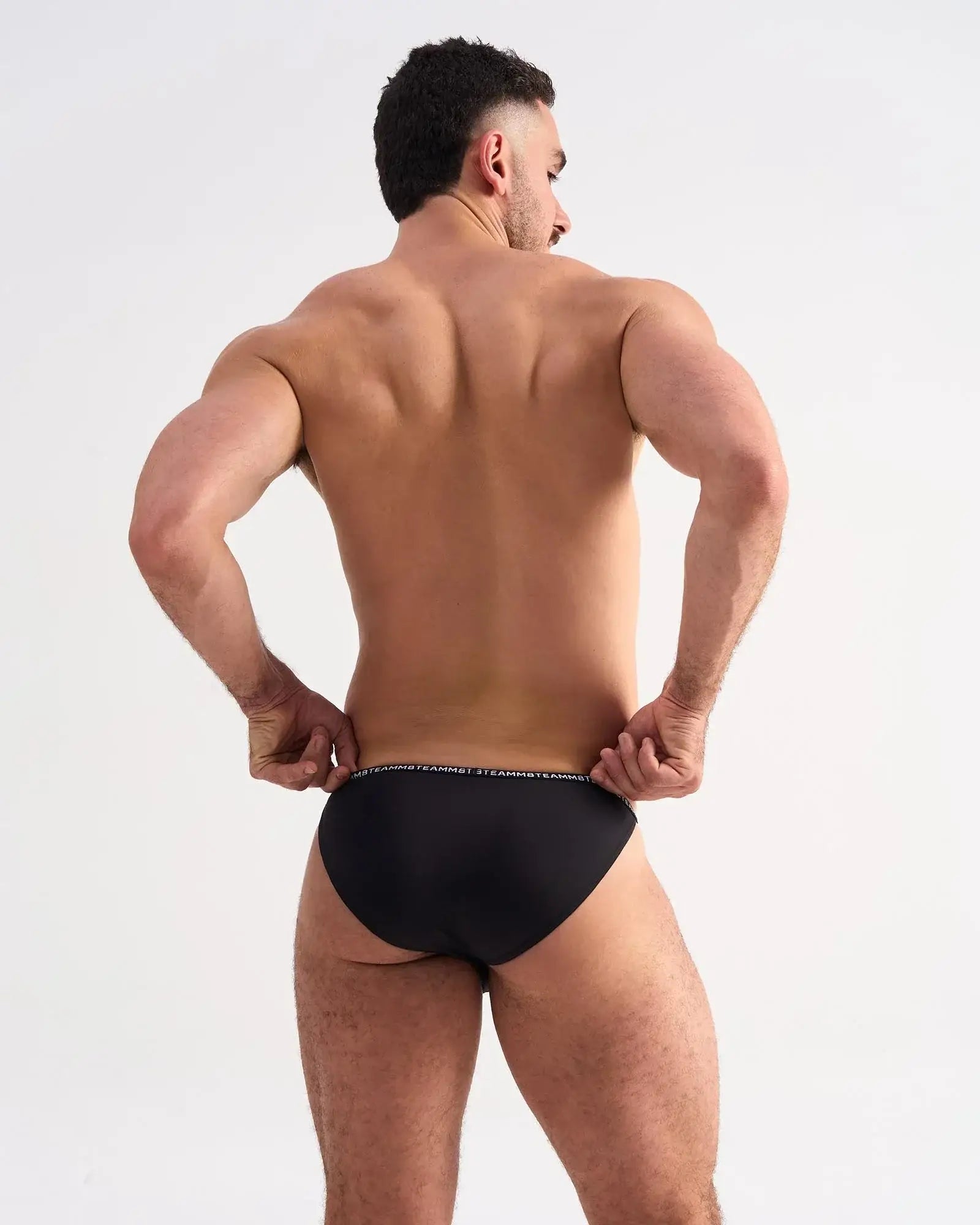 Black glide micro brief with subtle white logo trim on waistband featuring breathable microfiber fabric
