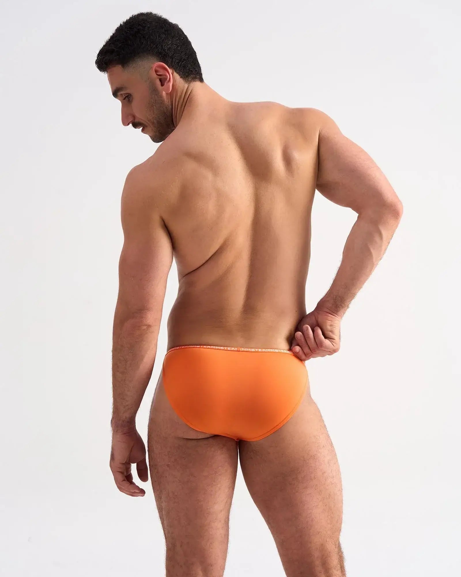 Bright orange glide micro brief with subtle white trim along the waistband for comfortable everyday wear