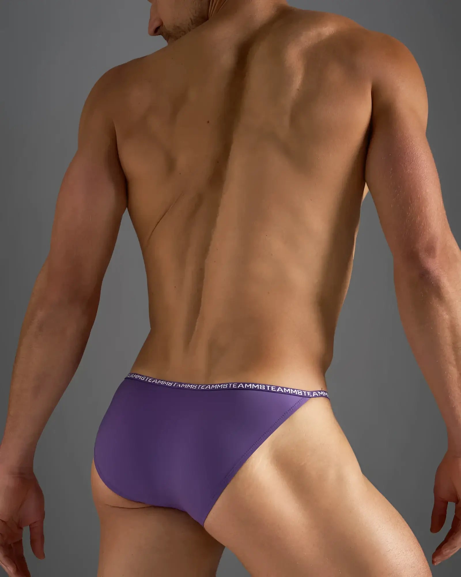 Purple glide micro brief athletic briefs with a white repeating logo waistband designed for active wear