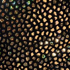 Black fabric gold stones trunk decorated with scattered gold and iridescent rhinestones in a mosaic pattern