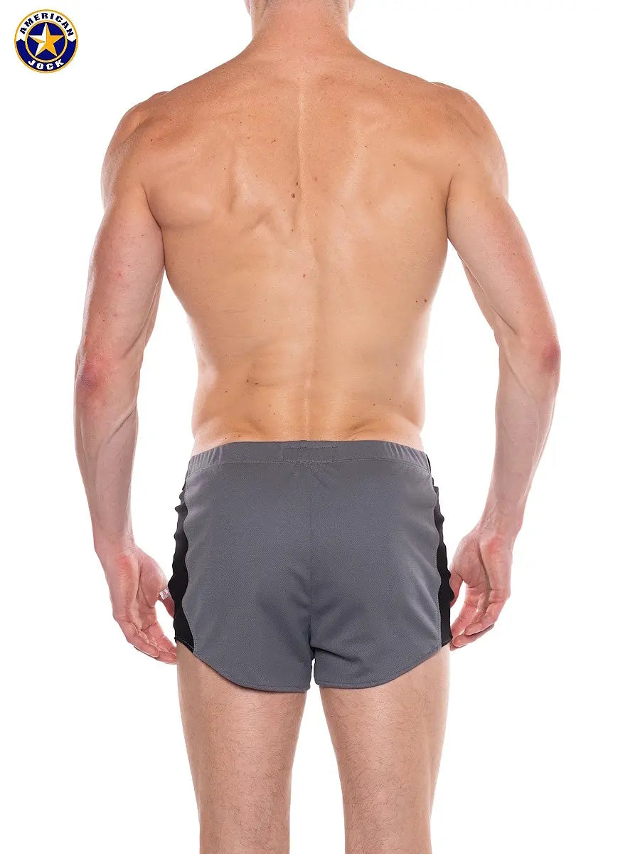 Back view of a man wearing gray and black short athletic shorts with an elastic waistband by AMERICAN JOCK