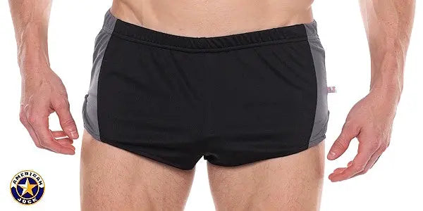 AMERICAN JOCK men's sprint shorts in black with gray side panels elastic waistband worn by a model showing front view