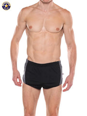 Male model wearing black and gray athletic sprint shorts with elastic waistband by AMERICAN JOCK