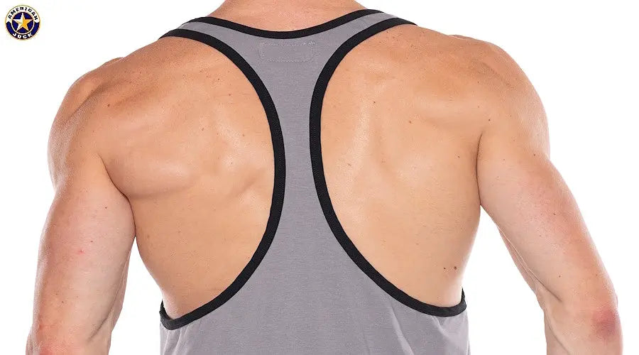 Back view of a man wearing a gray racerback tank top with black trim from American Jock showing muscular shoulders and upper back