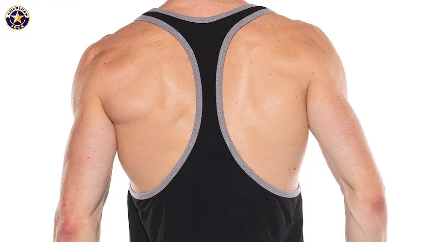 Back view of a man wearing a black tank top with gray trim and racerback design by AMERICAN JOCK