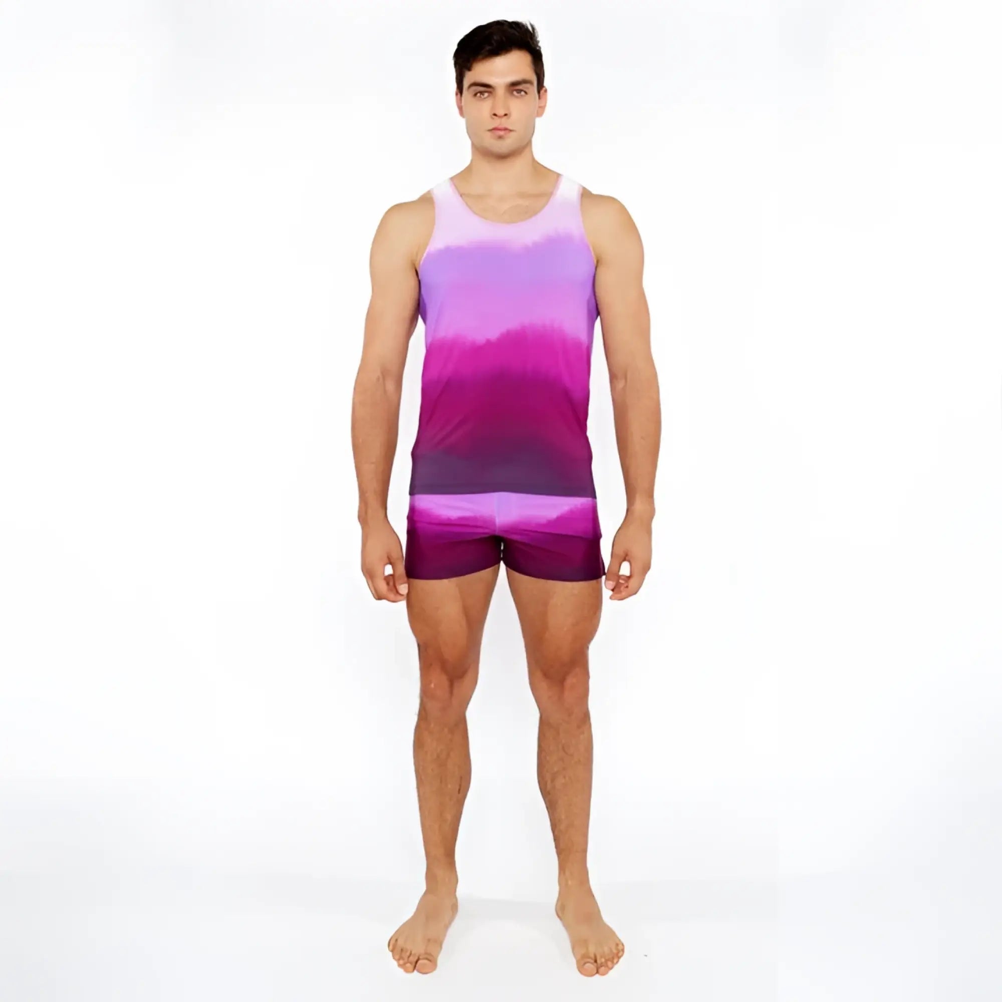 A man wearing a gradient purple and pink tie-dye tank top with matching gradient printed swim shorts