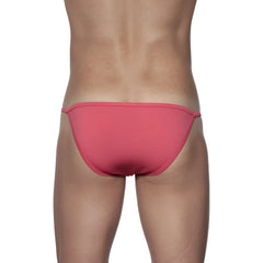 A sleek coral-pink groovin string bikini rouge red swim trunks with smooth fabric and thin side ties