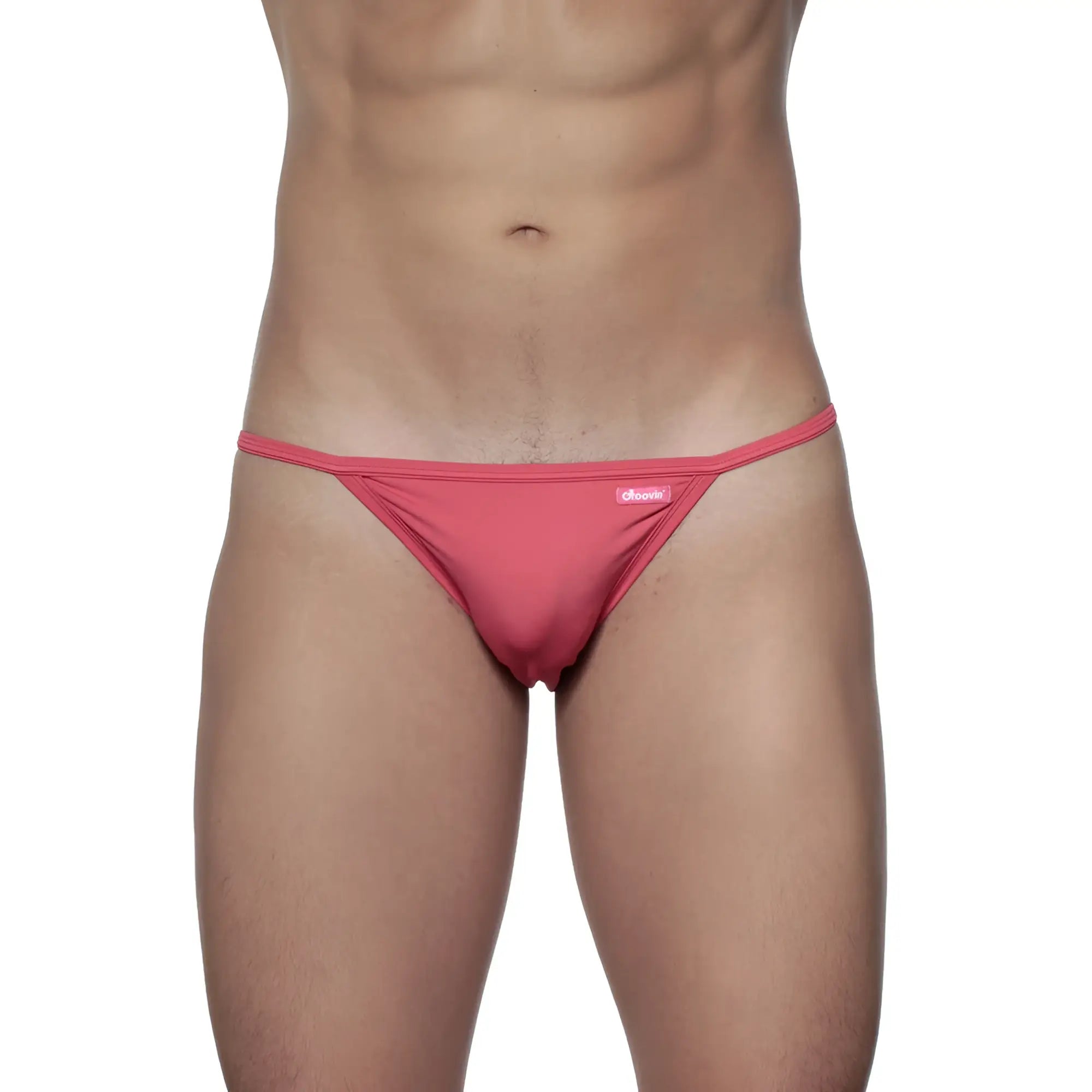 A vibrant pink groovin string bikini rouge red thong made of smooth stretch fabric with a small brand tag on the waistband