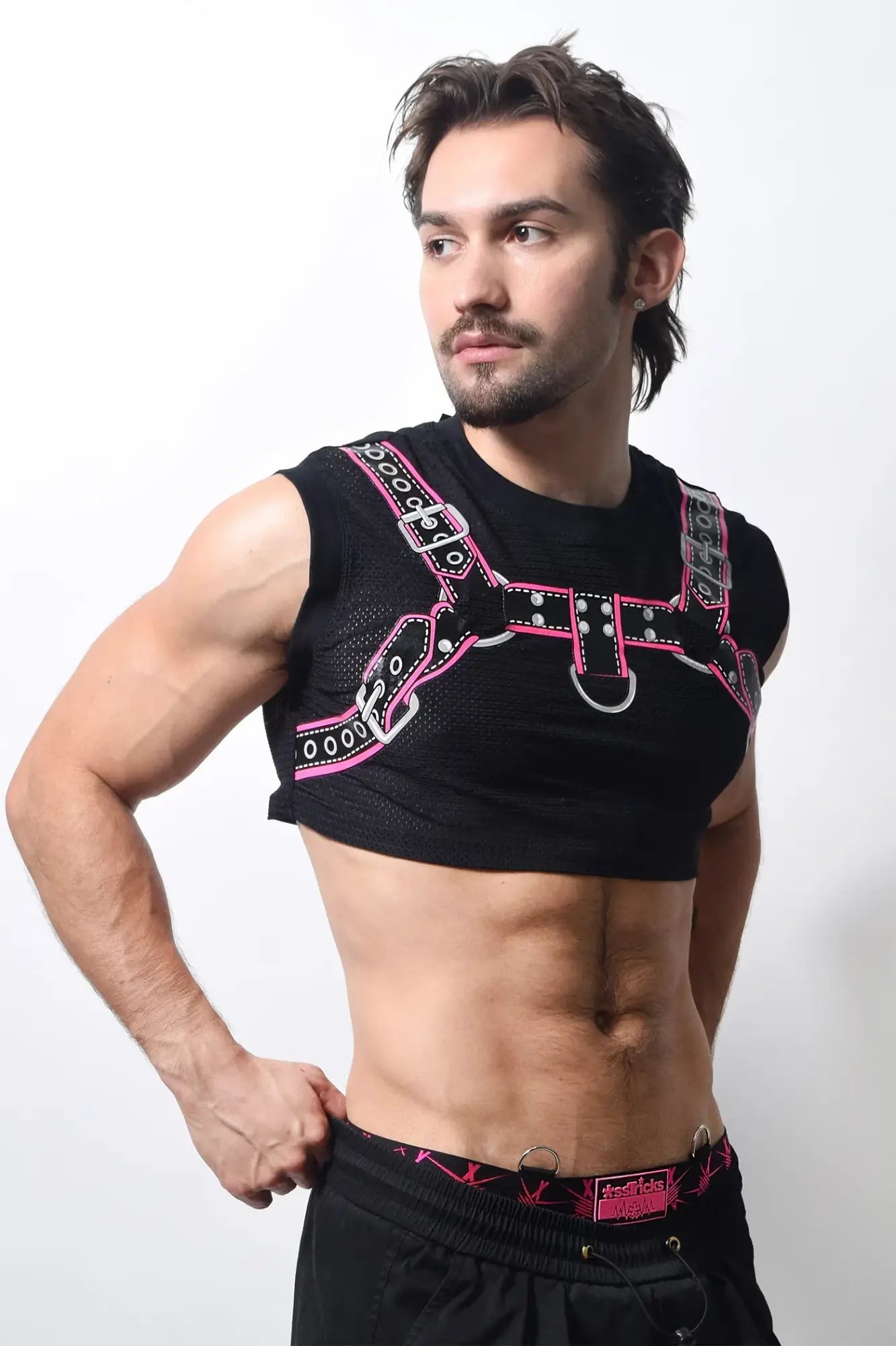 Harness crop top with black mesh body and pink silver leather straps featuring metal buckles and d rings
