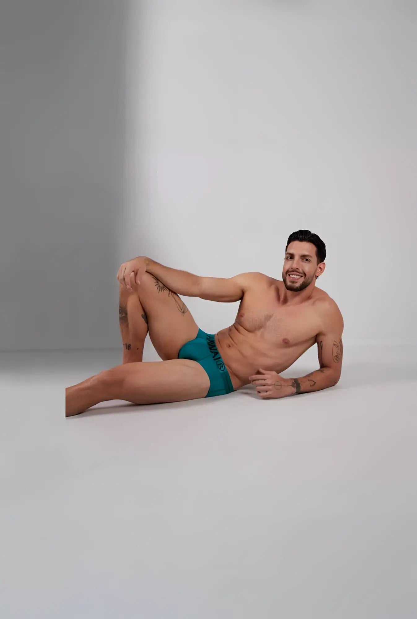 Teal green hawaï 41963 microfiber men’s briefs with a black logo waistband front side view