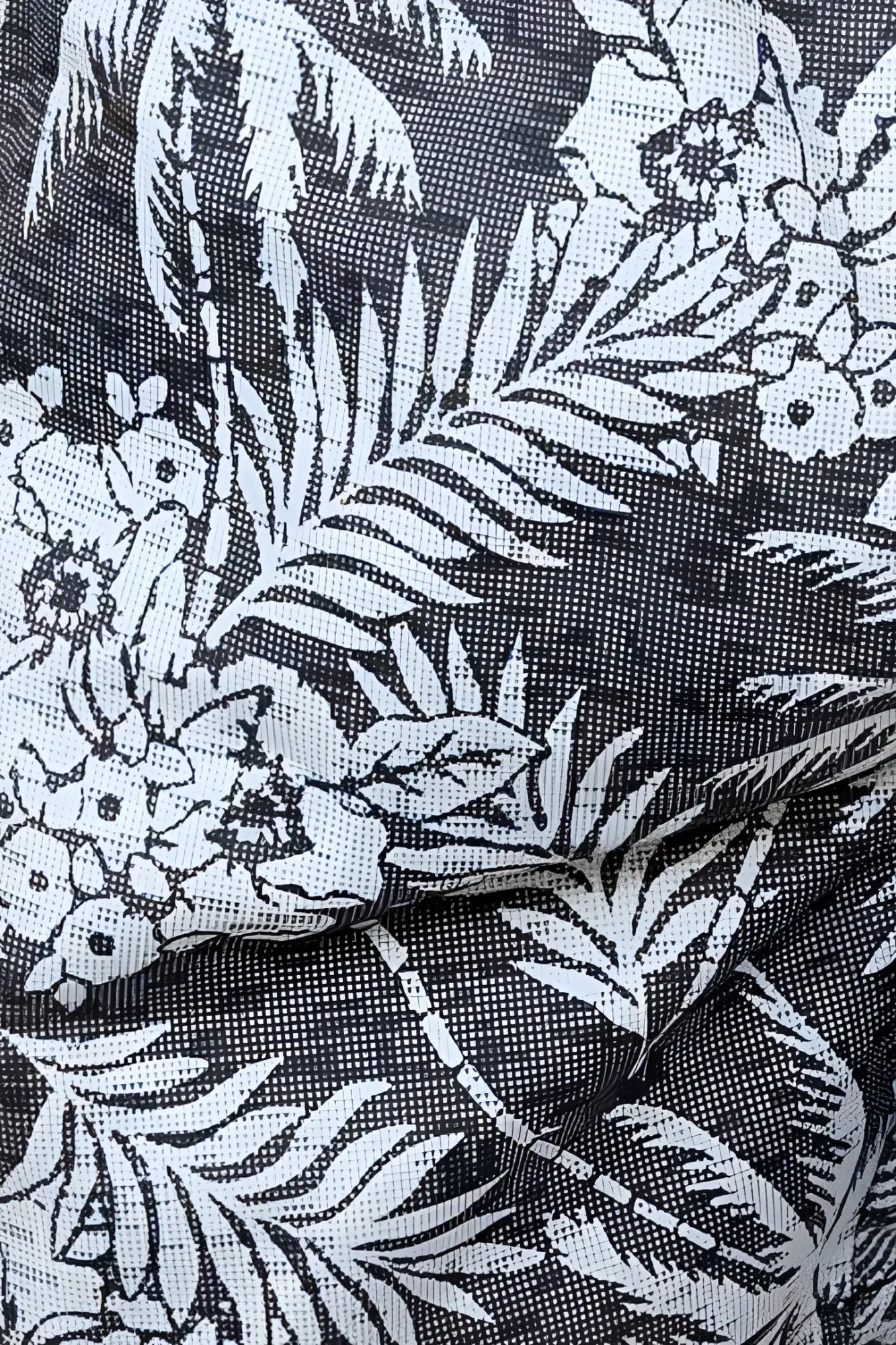 Hawaiian print swim short in black fabric with white tropical palm tree and flower pattern