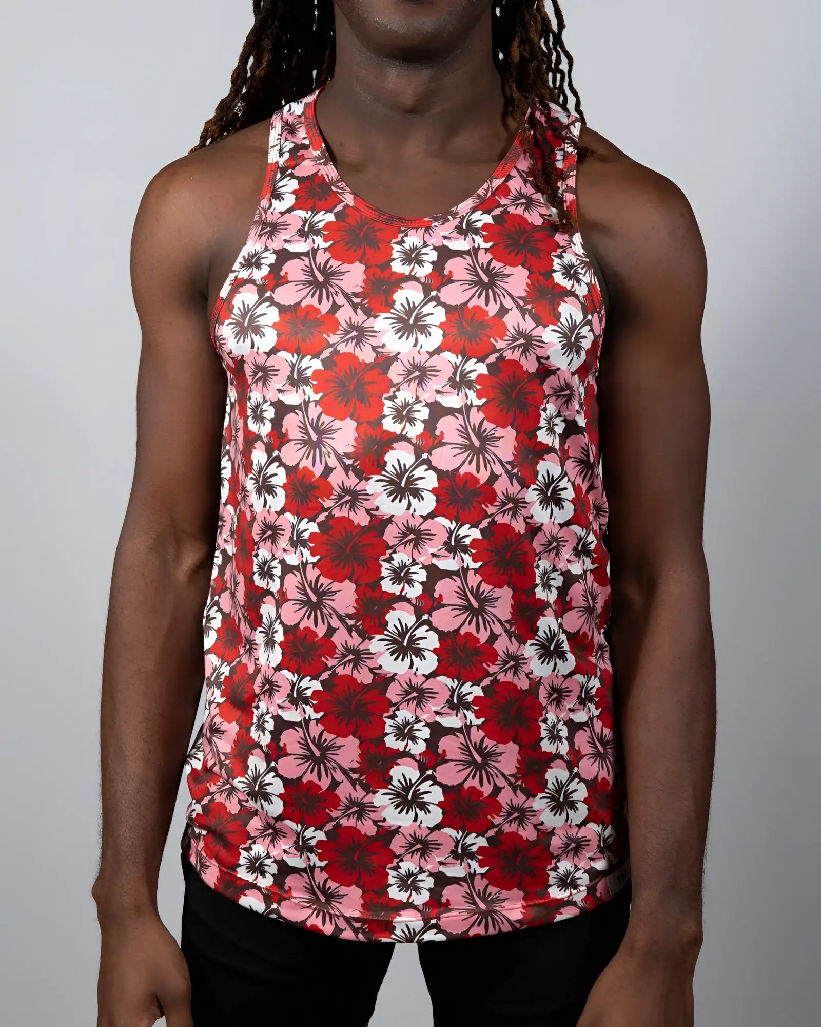 A vibrant red pink and white floral print hawaiian hibiscus tank top with a round neckline perfect for summer wear