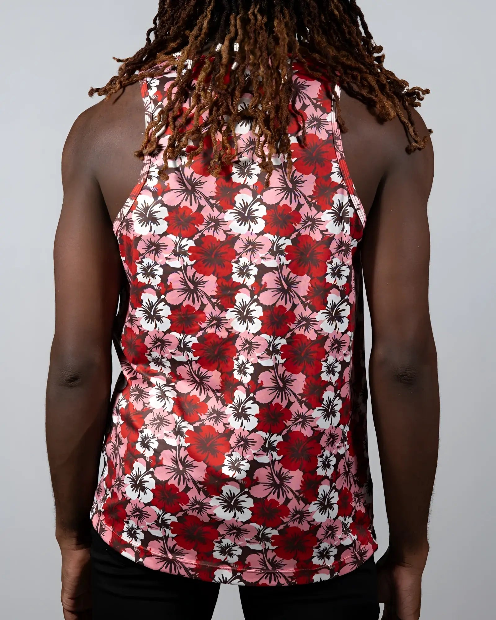 A vibrant red pink and white hibiscus print tank top with a black background perfect for casual summer wear