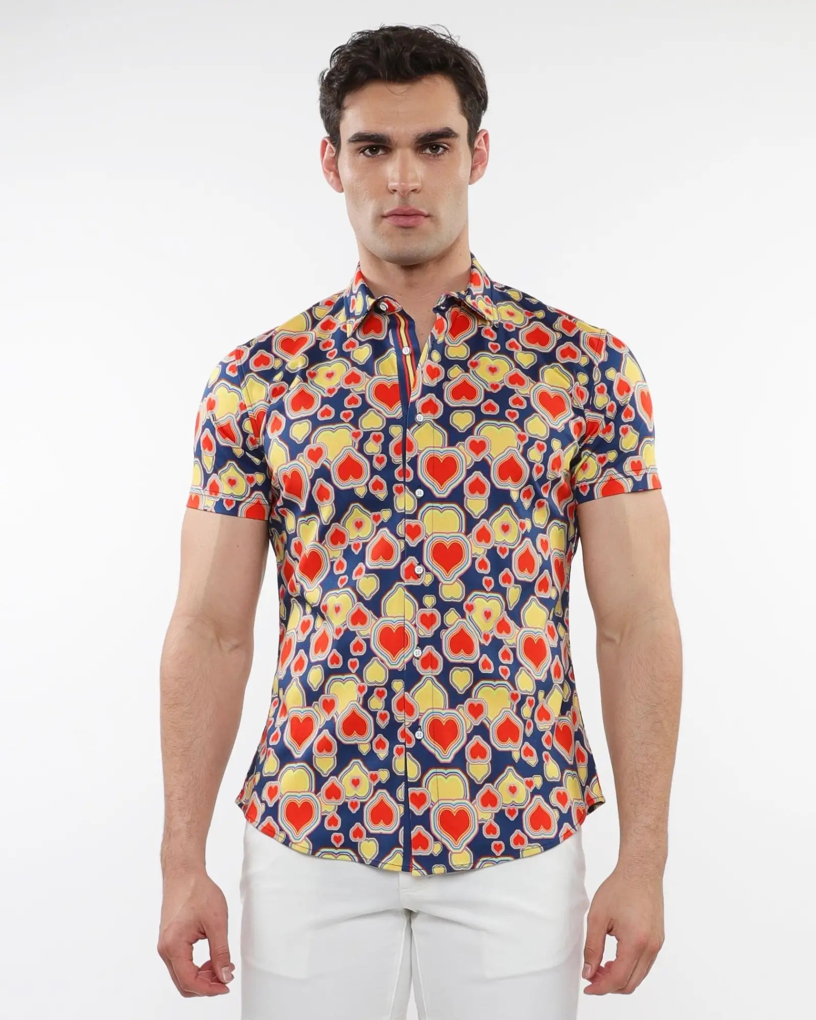 A vibrant stretch knit short-sleeved shirt with red and yellow hearts on a navy blue background
