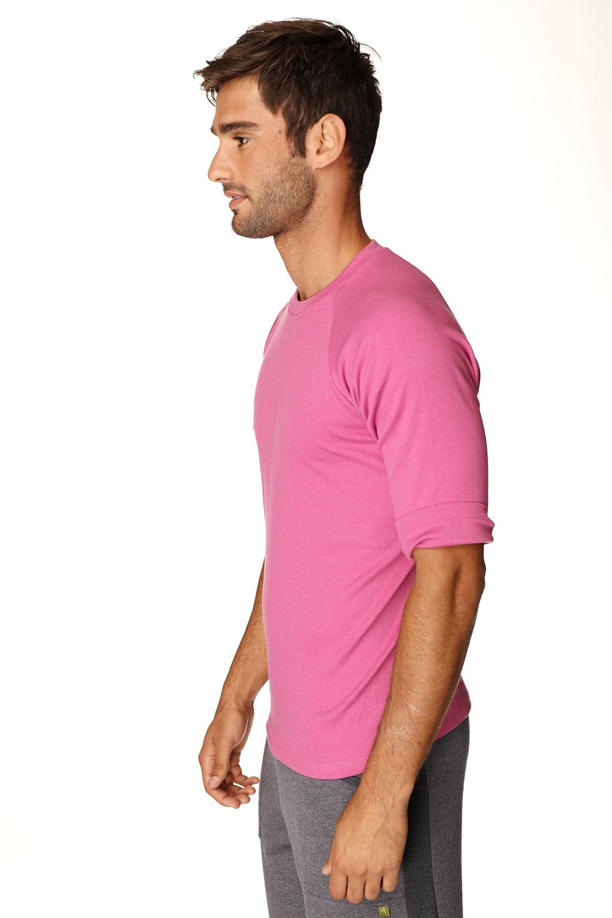 A vibrant pink hybrid crew neck raglan tee with short sleeves and rolled cuffs designed for athletic use