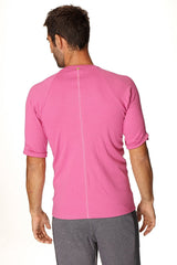 A vibrant berry pink hybrid crew neck raglan tee with textured fabric and short sleeves for athletic wear