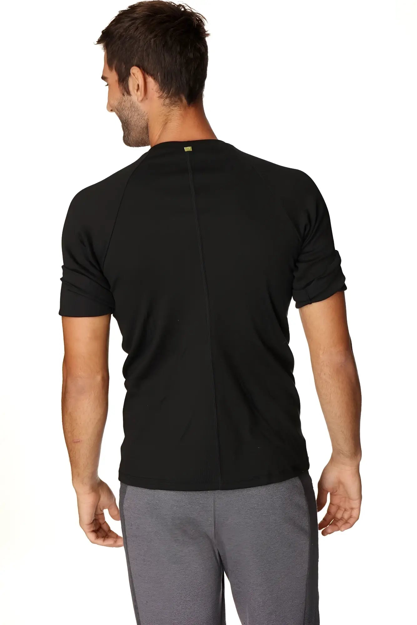 Black hybrid crew neck raglan tee back view with short sleeves, subtle vertical seam, and small green neckline logo