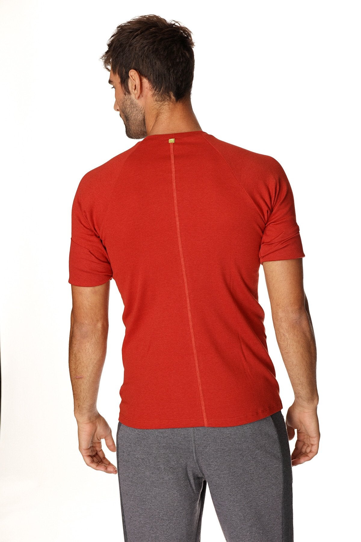 Red short-sleeved hybrid crew neck raglan tee with a central back seam shown from the back in cinnabar red