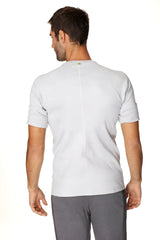 Back view of hybrid crew neck raglan tee in heather grey with subtle vertical seam and small green logo at neckline