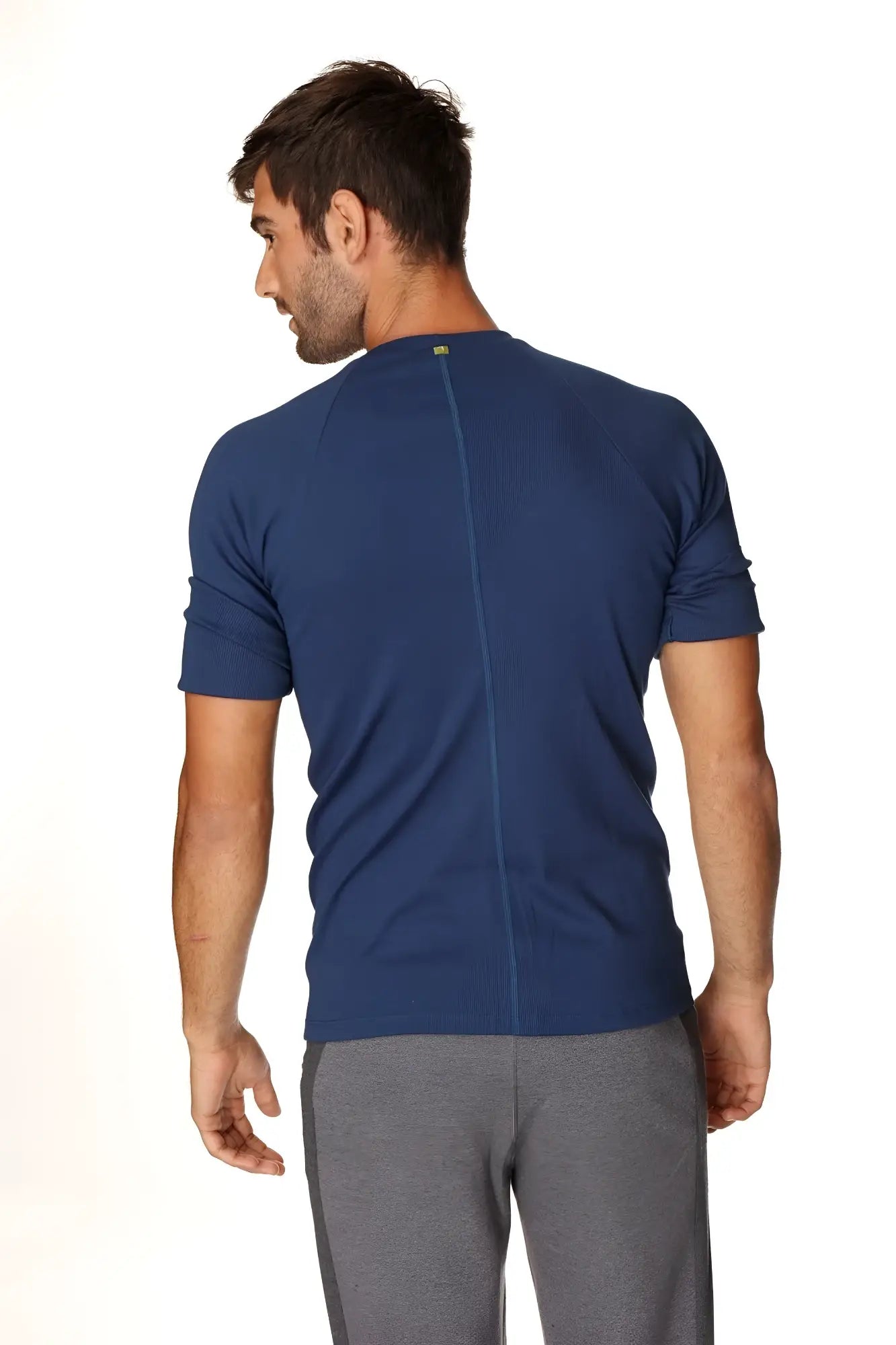 Navy blue short-sleeved athletic hybrid crew neck raglan tee shown from the back with a central seam for activewear use