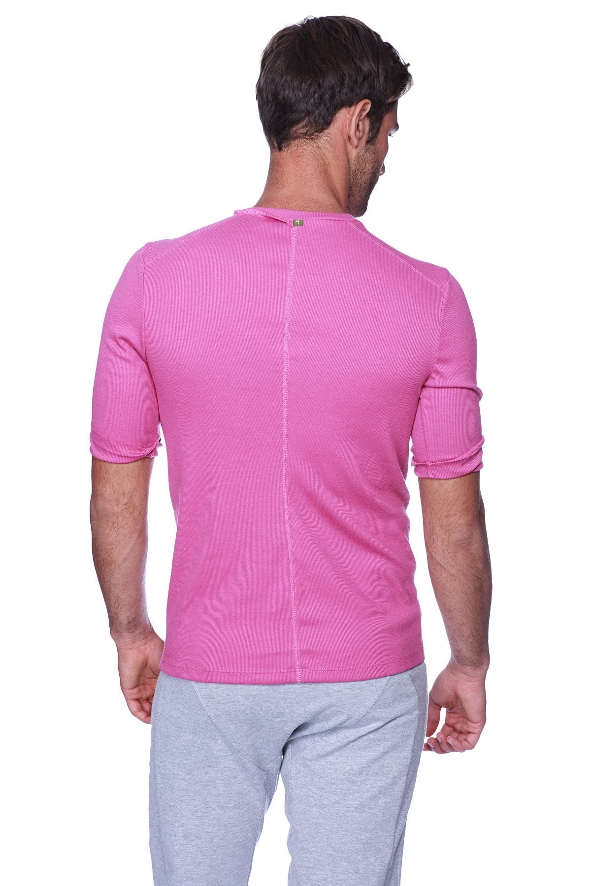 Back view of hybrid v neck berry vibrant pink short sleeved athletic shirt with ribbed textured fabric and vertical seam