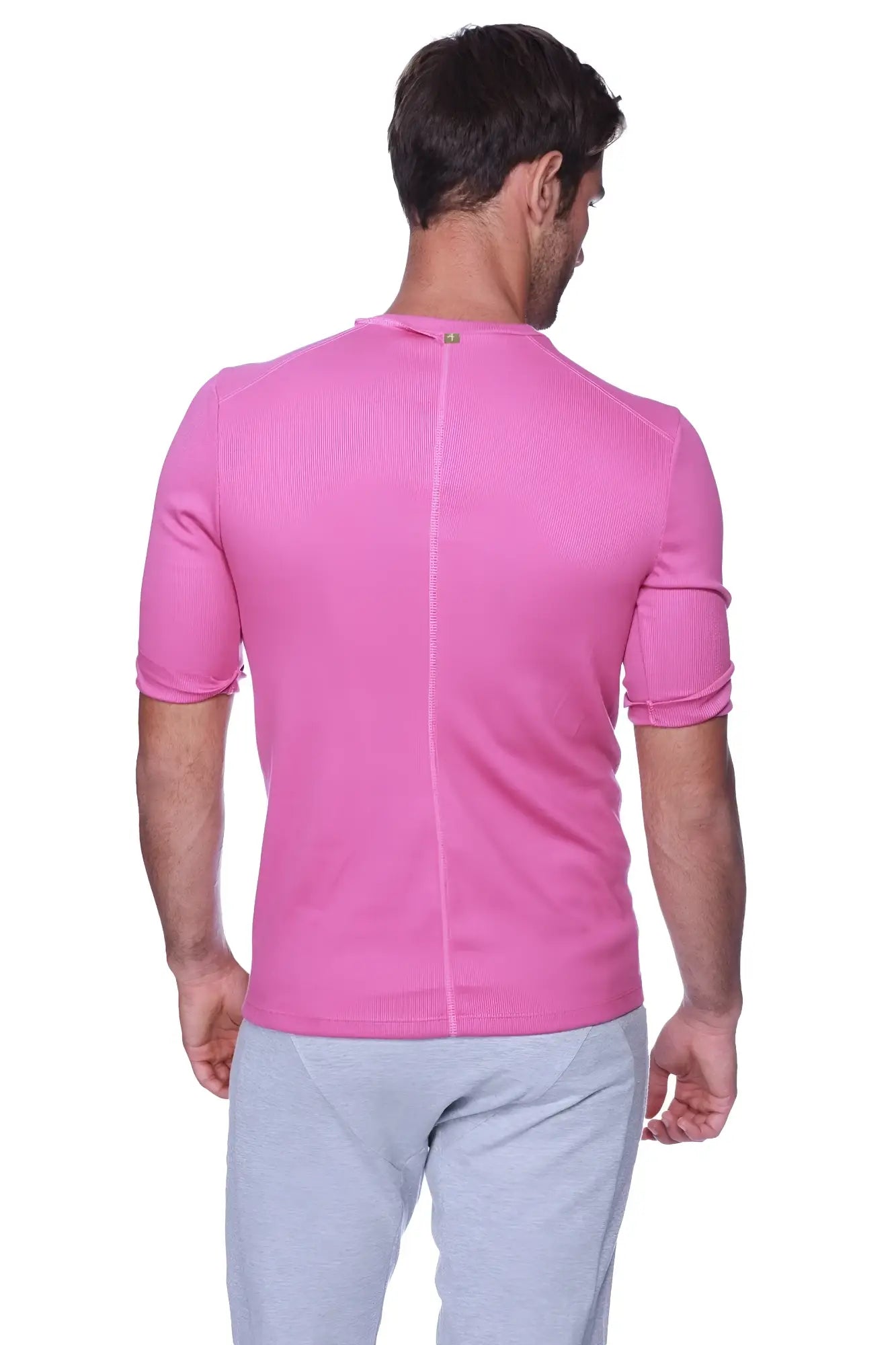 Back view of hybrid v neck berry vibrant pink short sleeved athletic shirt with ribbed textured fabric and vertical seam