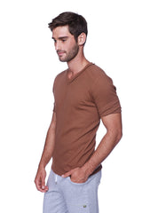 A man wearing a brown hybrid v-neck short-sleeved t-shirt made of soft breathable fabric