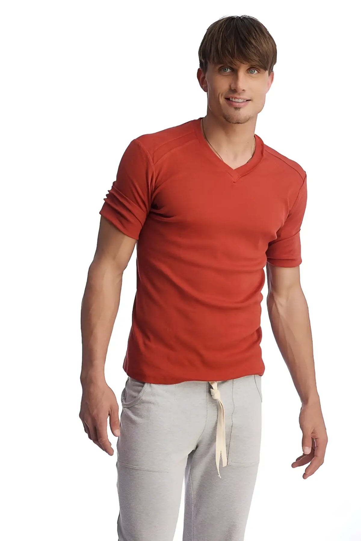 A men’s red hybrid v-neck short-sleeve t-shirt with textured fabric and rolled-up sleeves in cinnabar color