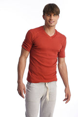 A men’s red hybrid v-neck short-sleeve t-shirt with textured fabric and rolled-up sleeves in cinnabar color