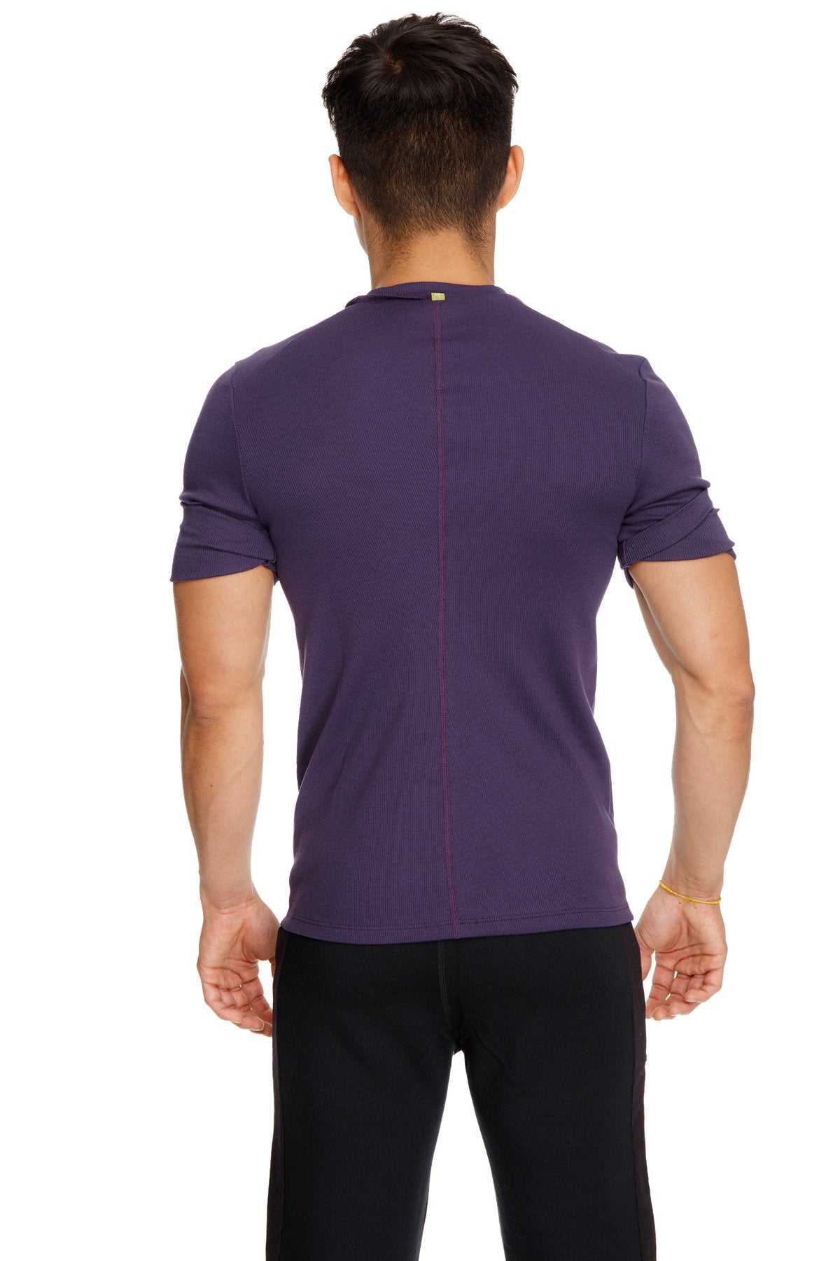 Back view of a purple hybrid v-neck short-sleeved athletic tee with a subtle vertical seam down the back