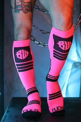 Hypnotix socks bright pink knee-high athletic socks with black ribbed panels and bold bulk branding on leg and toe