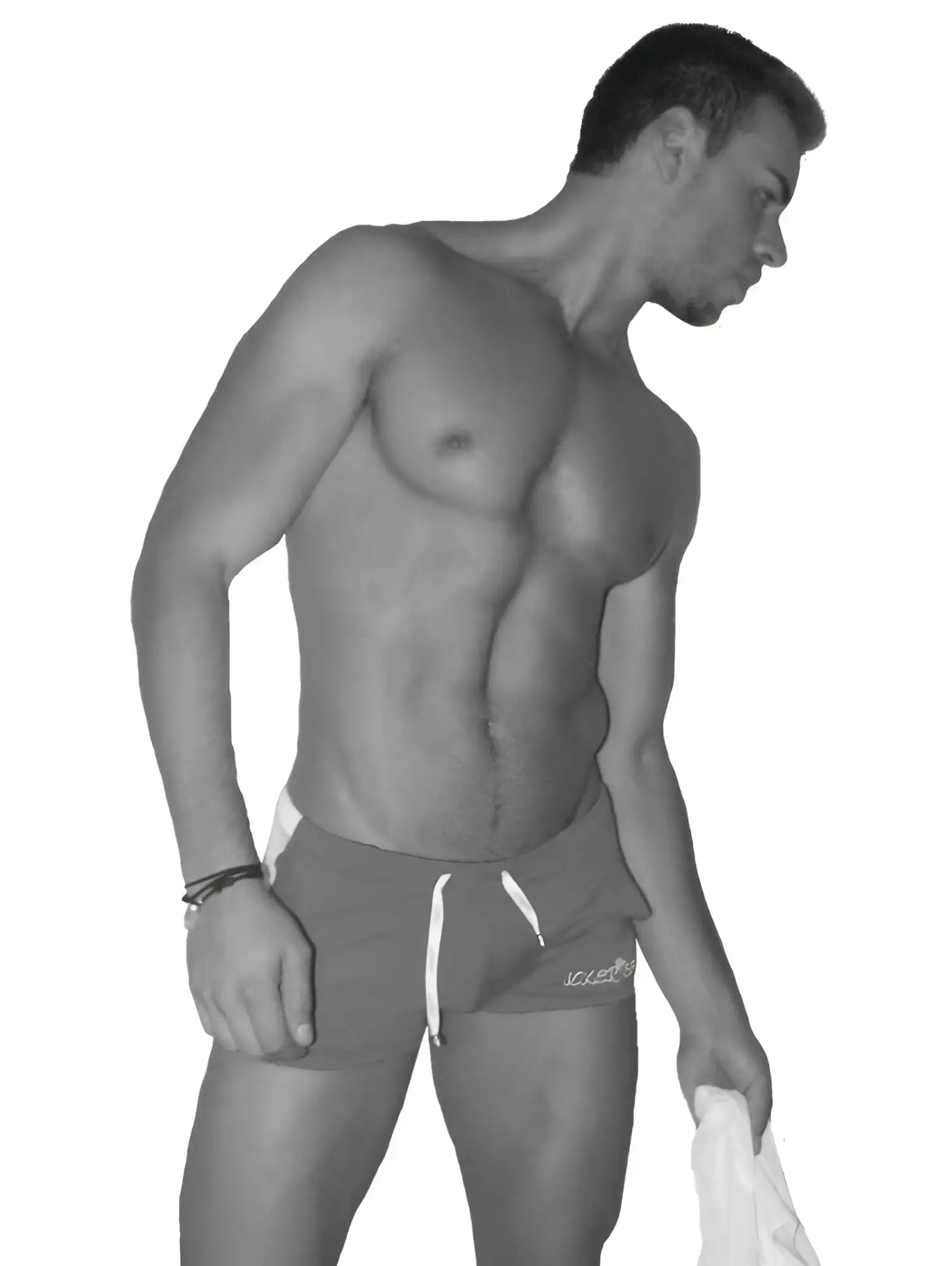 A man wearing icker sea air fitness side stripe black shorts with white drawstrings and logo on lower right leg